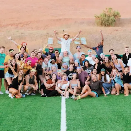 Group of students posing for a photo on the CUI field